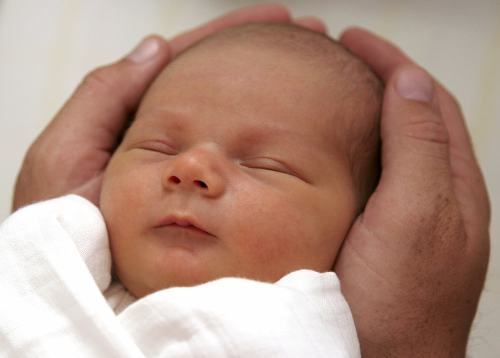 Baby receiving gentle Craniosacral therapy treatment